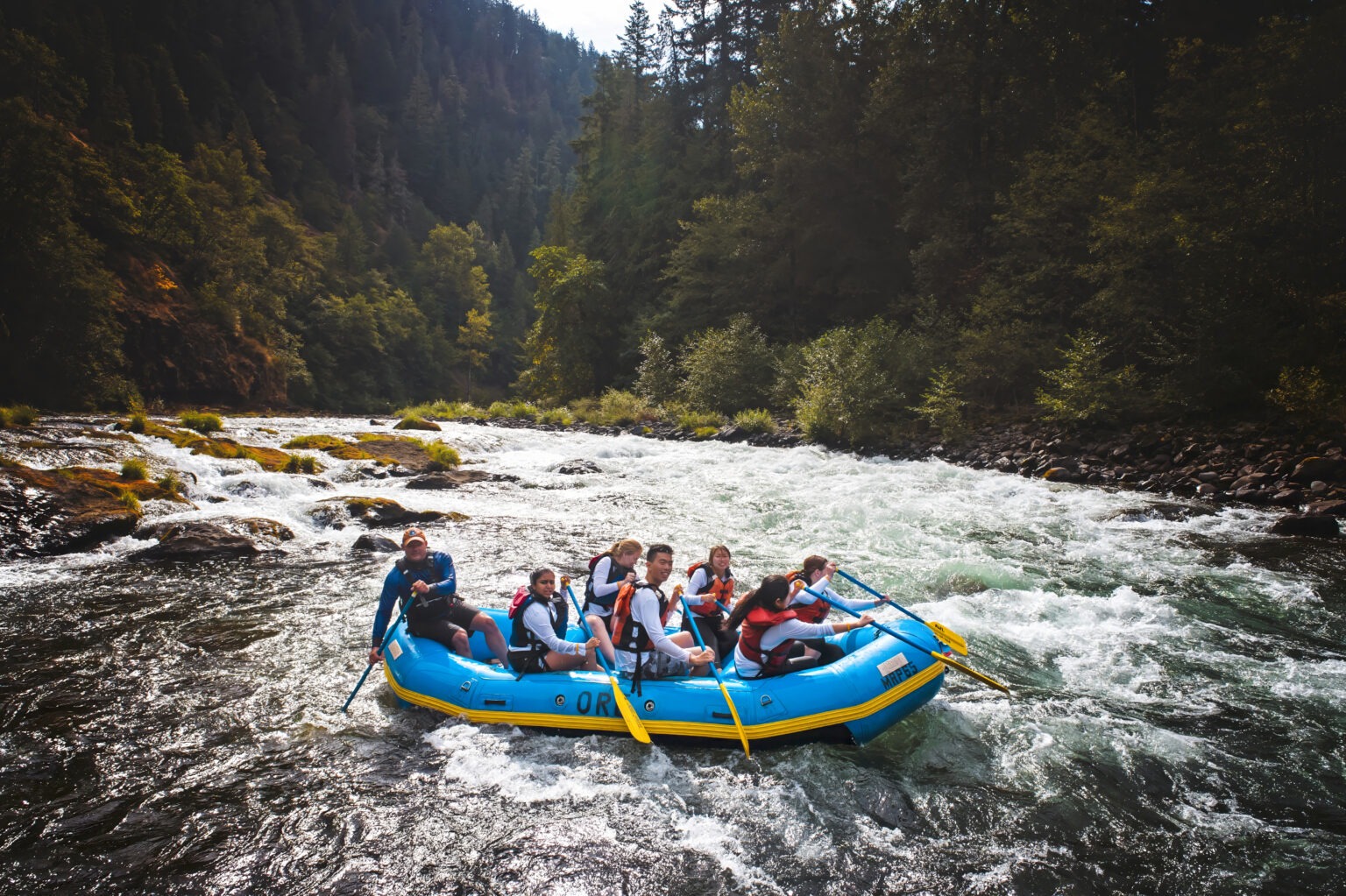 Corporate team from Veeva Systems navigating white-water rapids during their global leadership retreat in Portland, Oregon — photographed by David Scarola Photography.