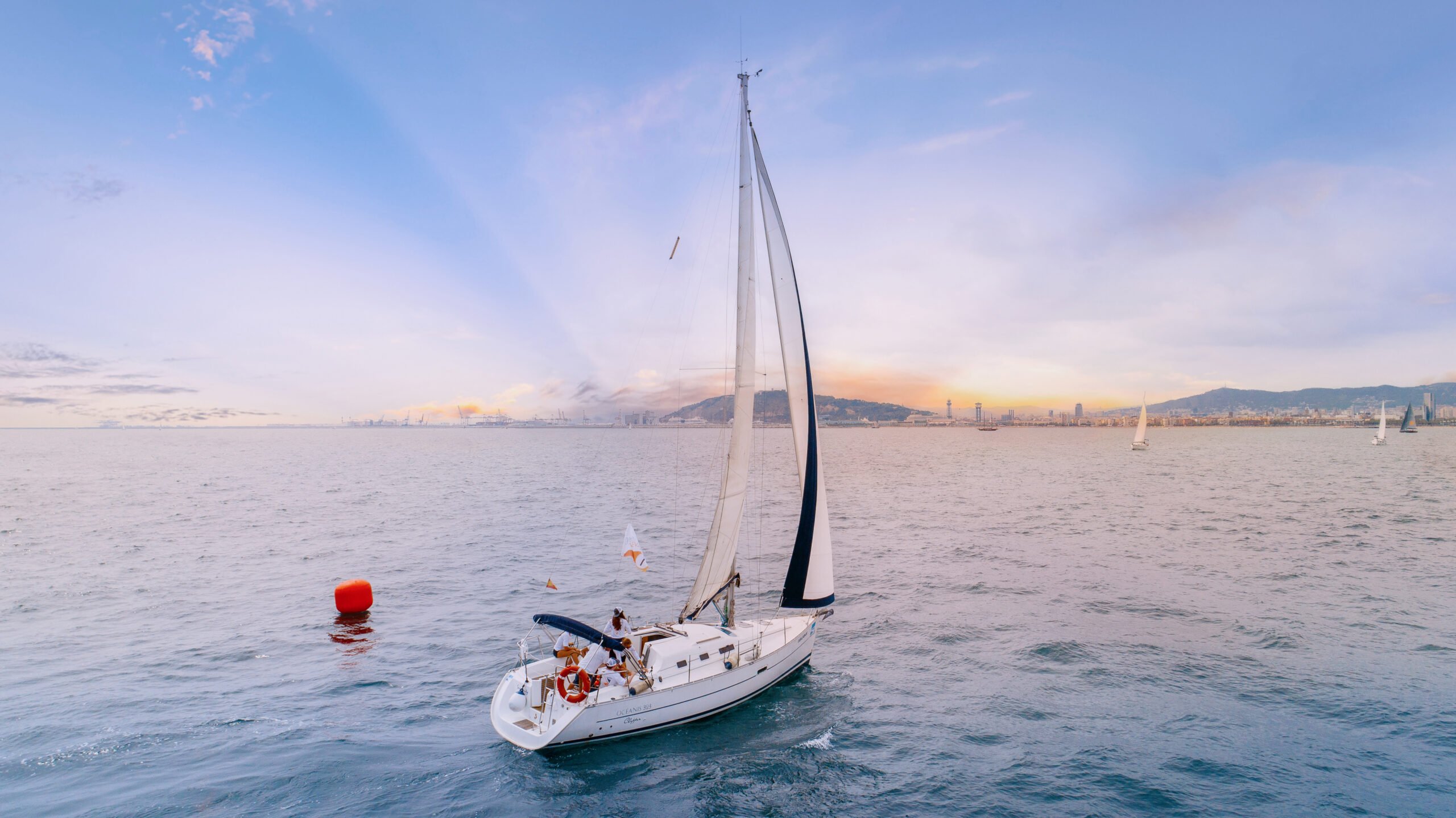 Luxury sailboat gliding across the Mediterranean Sea at sunset during the Generation Veeva global conference in Barcelona, Spain — captured by David Scarola Photography. The image reveals a blend of corporate elegance and Mediterranean serenity, with panoramic views of the Barcelona skyline and distant mountains.Veeva Systems Barcelona, Generation Veeva Global Conference, corporate yacht event Spain, Barcelona sailing photography, luxury corporate event photographer, Mediterranean sailing retreat, Barcelona aerial photographer, David Scarola Photography, global event photographer, luxury travel brand photography, Barcelona conference photography, executive retreat coverage, fine art event photography, professional corporate branding photography, destination event photographer Europe, Mediterranean yacht lifestyle photography, Barcelona skyline at sunset, innovation leadership event photography.