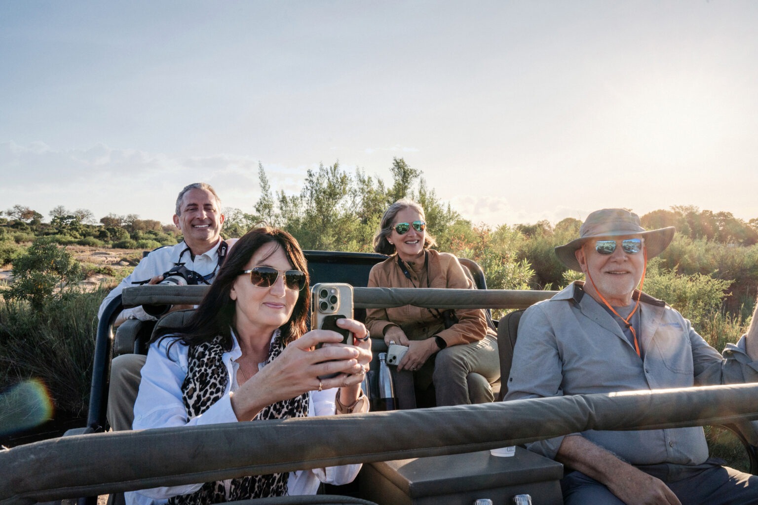 A joyful safari expedition at Mala Mala Game Reserve in Sabi Sands, South Africa, during the International Academy of Trial Lawyers Global Adventure. Four travelers capture wildlife moments and golden African light from an open-air vehicle — an elegant fusion of exploration, connection, and fine-art storytelling by David Scarola Photography.Mala Mala Game Reserve photography, Sabi Sands safari photographer, South Africa event photography, International Academy of Trial Lawyers expedition, global corporate retreat photographer, luxury travel photography, destination event photographer, safari adventure coverage, African wildlife photographer, David Scarola Photography, global event coverage, fine art travel imagery, corporate adventure photography, high-end travel documentation, experiential event photographer, international retreat photography, Africa luxury expedition, storytelling photography, professional event coverage worldwide.