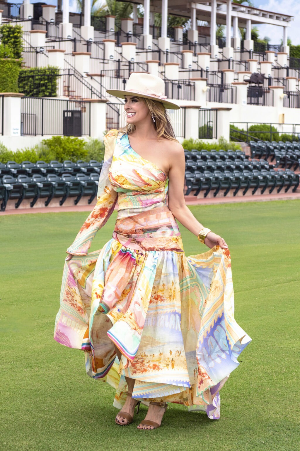 Editorial fashion photo at the USPA National Polo Center in Wellington, Florida, featuring a model wearing a colorful designer dress by Kirna Zabete boutique of Palm Beach, photographed by David Scarola Photography for a luxury fashion and lifestyle campaign.David Scarola Photography, Kirna Zabete Palm Beach, fashion boutique Palm Beach, USPA National Polo Center Wellington, International Polo Club Palm Beach, Metropolitan Magazine cover shoot, Palm Beach fashion photographer, Jupiter Island fine art photographer, luxury fashion editorial Florida, resort fashion campaign Palm Beach, high-end lifestyle photography, best portrait photographer in Florida, couture editorial photography USA.