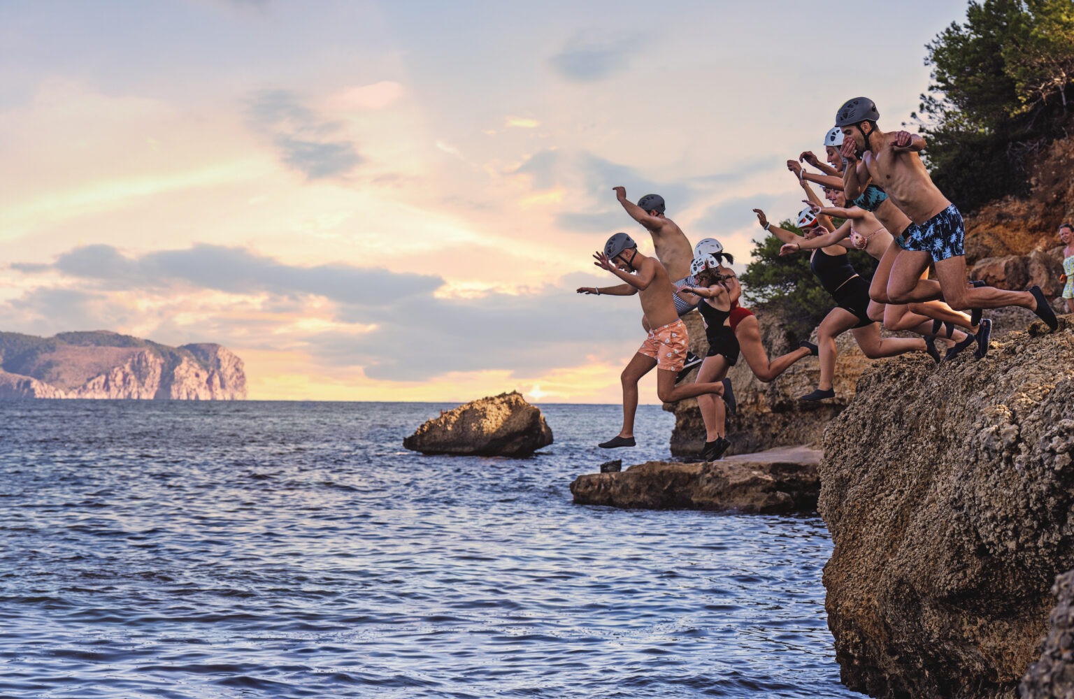 Corporate team from Veeva Systems cliff jumping into the Mediterranean Sea during their global summit in Mallorca, Spain — captured by David Scarola Photography.Veeva Systems global conference Mallorca, corporate retreat photographer Spain, luxury event photographer Europe, executive team adventure photography, Mallorca corporate photography, destination corporate photographer, David Scarola Photography, global event coverage, team building photography, business summit photographer, high-end conference photography, worldwide corporate storytelling, Mallorca cliff jumping corporate retreat.