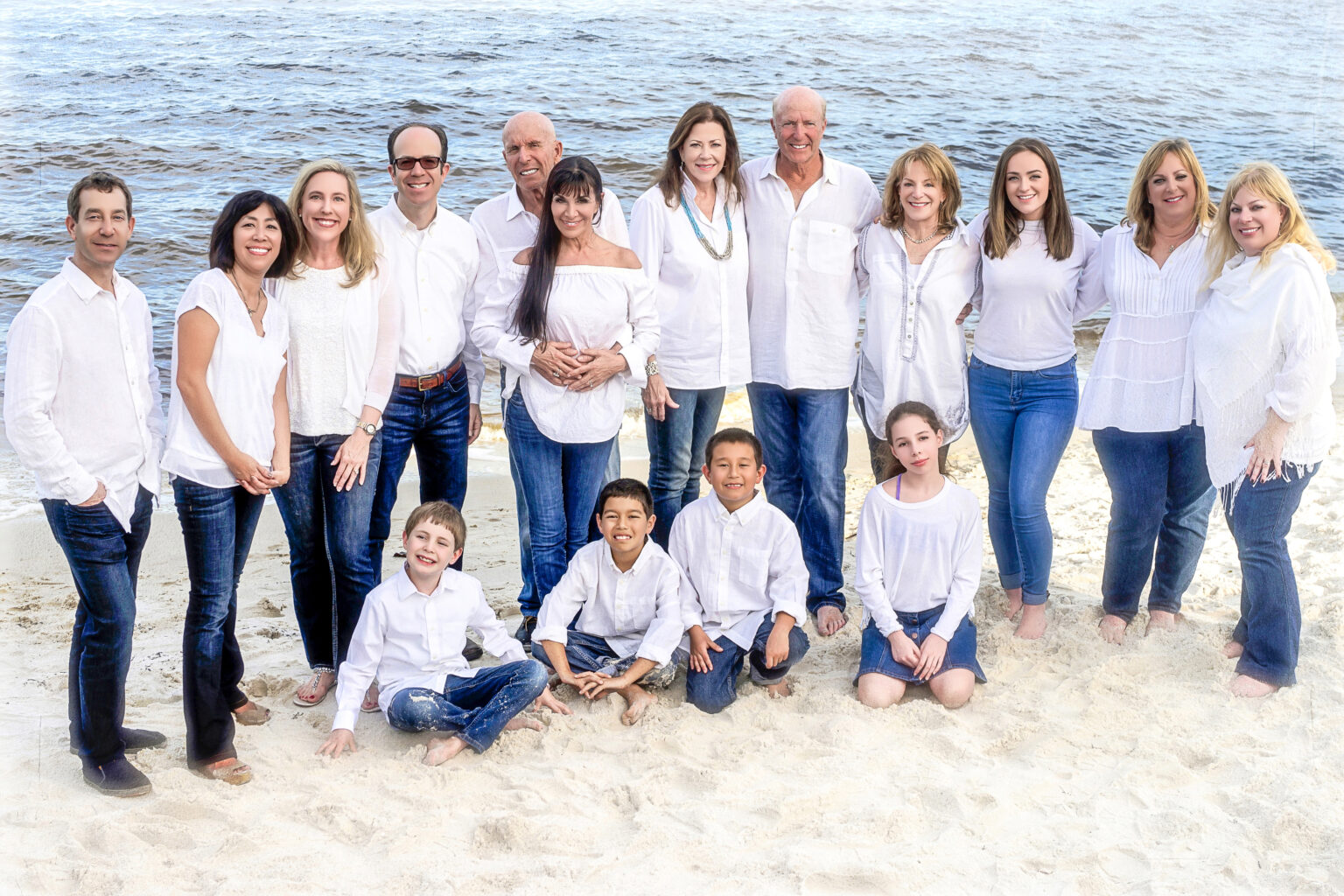 Extended family photography sessions with David Scarola. Everybody wearing their white shirts, their denim, their smiles, their open hearts, and the day is unfolding perfectly. A large family in Jupiter Island enjoying their family photography session with artist and master photographer, David Scarola.