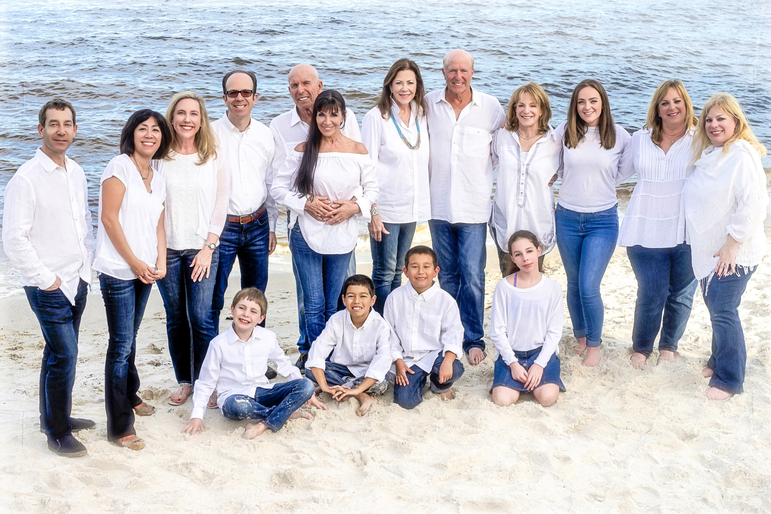 Extended family photography sessions with David Scarola. Everybody wearing their white shirts, their denim, their smiles, their open hearts, and the day is unfolding perfectly. A large family in Jupiter Island enjoying their family photography session with artist and master photographer, David Scarola.