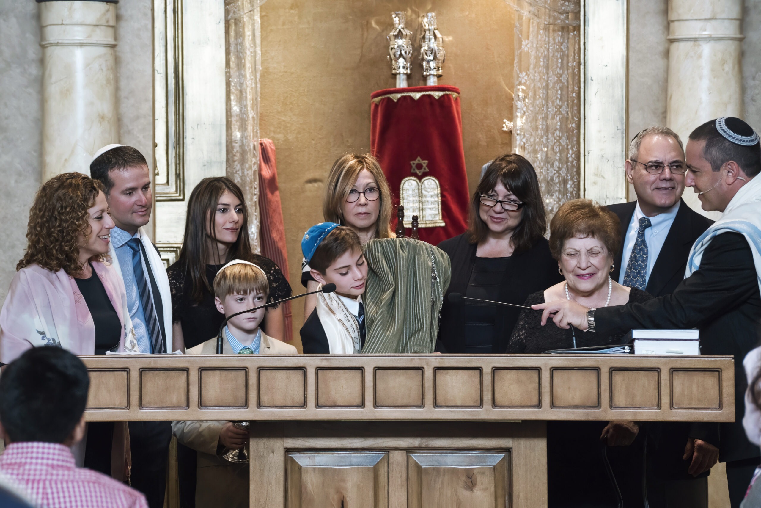Matthew Smith’s Bar Mitzvah ceremony at Temple Beth Am in Jupiter, Florida. Surrounded by family and community, Matthew stands at the bimah holding the Torah as the rabbi leads a sacred blessing under the warm light of the sanctuary.Bar Mitzvah photographer Jupiter Island, Temple Beth Am events, Palm Beach luxury event photography, Jewish family celebration photography, David Scarola Photography, professional event photographer Florida, high-end family photography Palm Beach, private milestone photographer, global event photography, luxury portrait artist Florida.