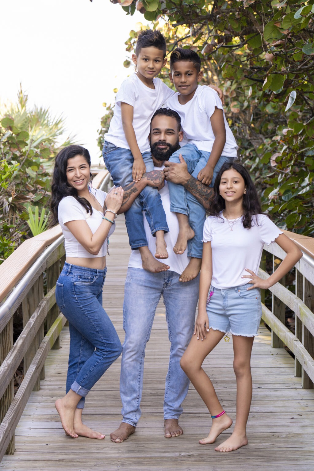Masterfully posed, by world renowned portrait artist and the best family photographer in Florida, this gorgeous family is on the boardwalk at Coral Cove Park on Jupiter Island, enjoying every moment of their photo shoot experience with David Scarola.