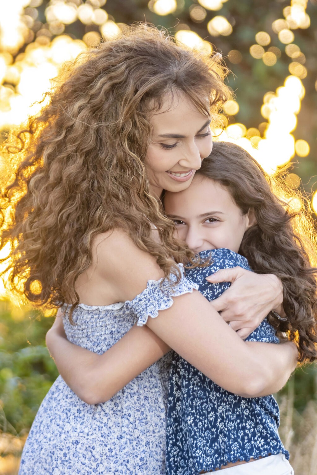 Mother and daughter sharing a loving embrace at Admirals Cove in Jupiter, Florida — captured in glowing golden-hour light by award-winning Palm Beach family photographer David Scarola. Warm, emotional family portrait radiating connection, love, and natural beauty.family photographer Jupiter FL, family portraits Palm Beach, Admirals Cove family photography, mother daughter photoshoot, golden hour family portraits, best portrait photographer South Florida, luxury family photography, Scarola Style portraits, emotional family photography, lifestyle portraits Palm Beach Island.