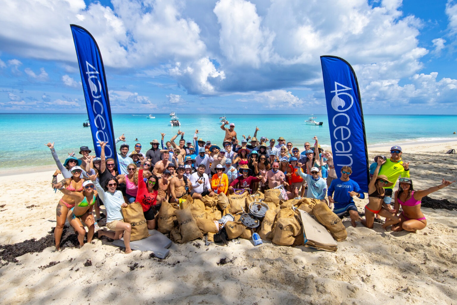 Global cleanup with 4Ocean in Bimini, Bahamas during the annual Crossing for Cystic Fibrosis event. Volunteers celebrate after collecting hundreds of pounds of ocean debris under bright blue skies, photographed by David Scarola, official event photographer for the Crossing for Cystic Fibrosis.4Ocean photography, environmental event photographer, Bimini Bahamas event photography, ocean cleanup photography, worldwide event photographer, adventure photographer, corporate and nonprofit event photographer, Crossing for Cystic Fibrosis, global sustainability photography, ocean conservation photographer, David Scarola Photography, top Florida event photographer, luxury destination event photography, editorial event documentation, official event photographer, best adventure photographer USA.