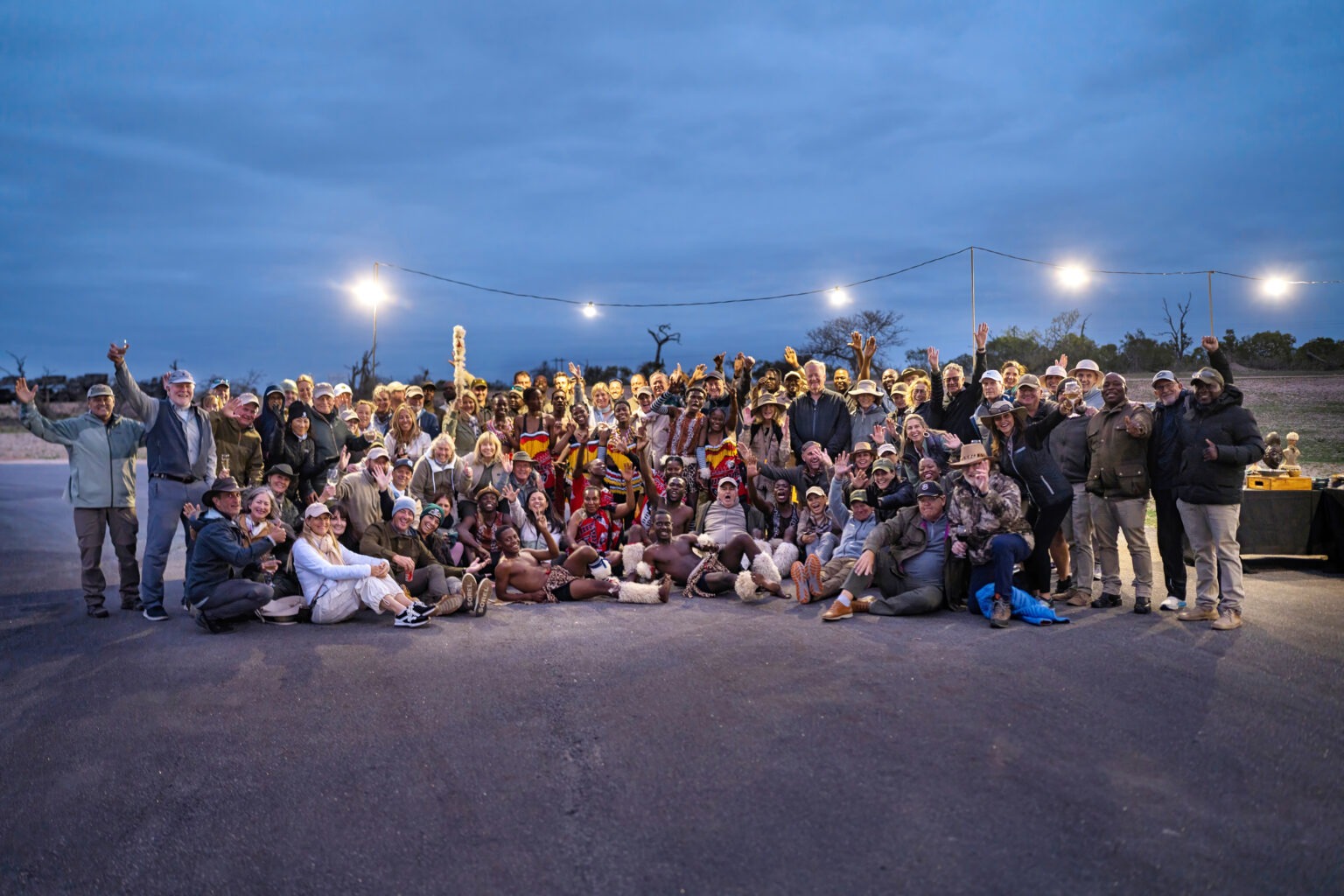 Group photo of global professionals and adventurers at Mala Mala Game Reserve in South Africa during a corporate summit safari — captured by David Scarola Photography, showcasing unity, culture, and world-class event coverage.