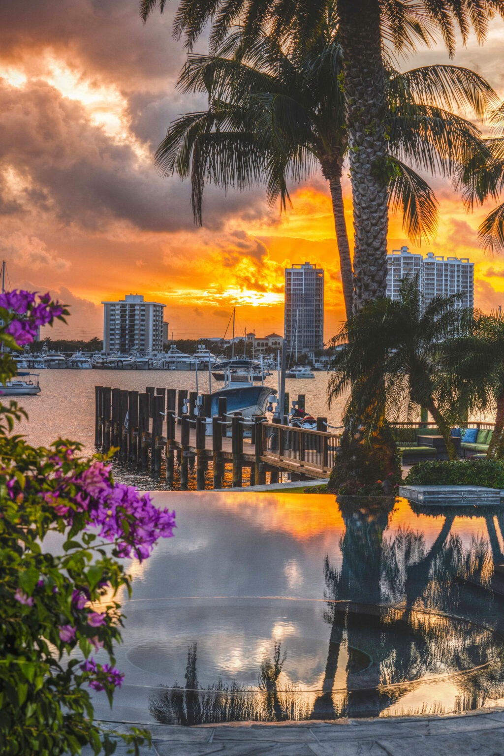 Sunset over a luxury Palm Beach waterfront estate, showcasing a private dock, infinity pool, yachts, and tropical palm trees — photographed by David Scarola for a philanthropic event.David Scarola Photography, Palm Beach event photographer, philanthropic event photography, luxury estate event photography, Palm Beach waterfront photography, gala event photographer, full-coverage event photography Florida, professional event photographer Palm Beach, nonprofit gala photography, high-end event coverage, corporate and philanthropic events, Florida luxury photographer, elite event photography, social impact events Palm Beach, sunset event photography.