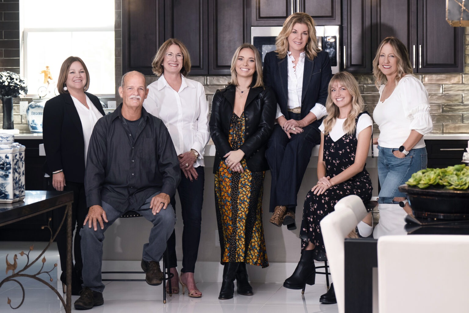 Corporate team portrait of a South Florida interior design firm, photographed in a modern kitchen setting. Seven design professionals, dressed in smart casual and business attire, represent their brand’s creative and professional excellence.interior design team photography, corporate team portraits Palm Beach, business headshots Jupiter Island, professional photography South Florida, creative agency team photo, group photography Miami, lifestyle corporate photographer, brand photography for design firms, Jupiter Island professional portraits, Palm Beach business photography, David Scarola Photography, team branding portraits, architectural and interior design marketing.