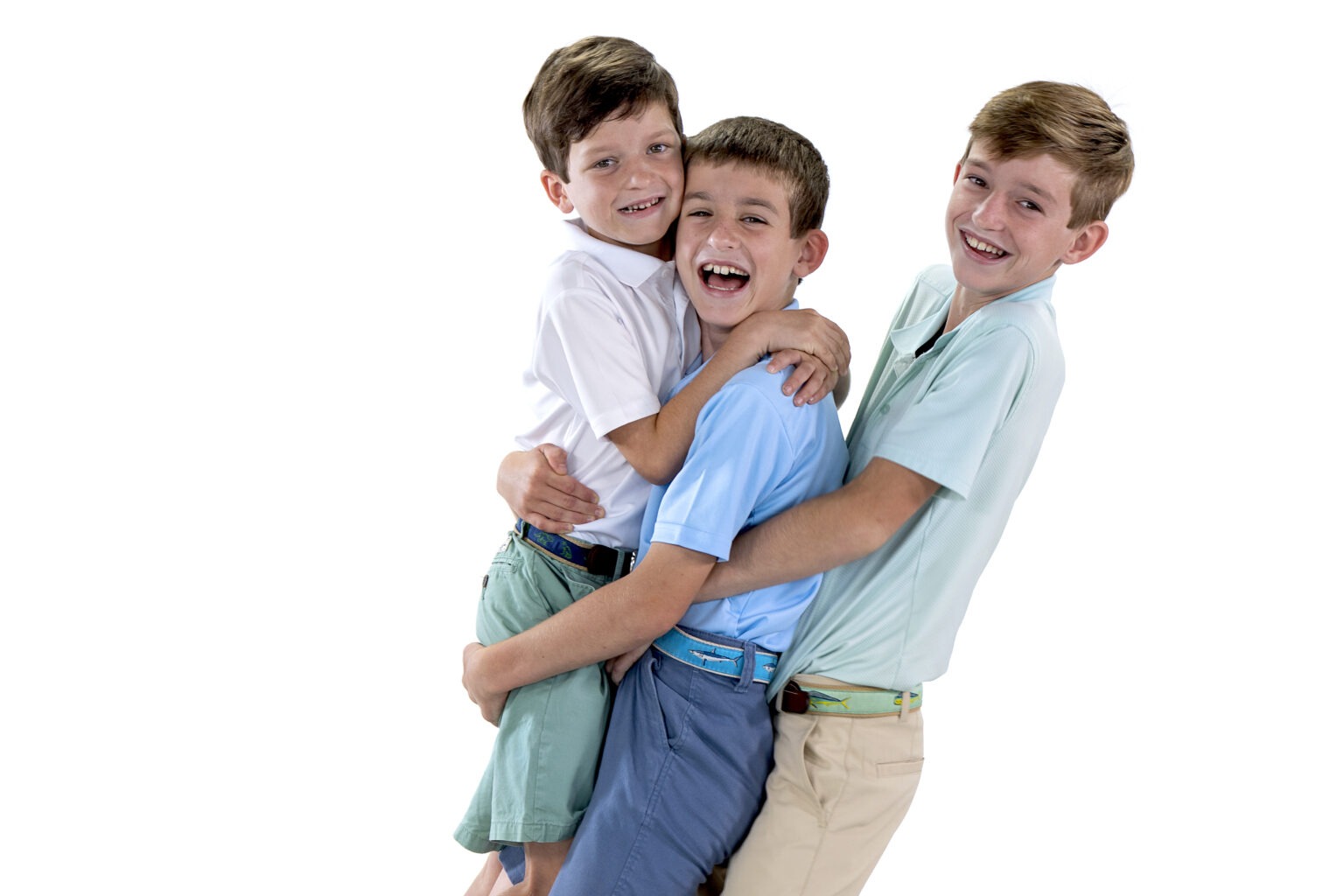 Studio family portrait of three brothers from the Irish family, captured in joyful embrace and laughter by professional photographer David Scarola in Jupiter, Florida. Bright, modern white-background studio photography showcasing connection, personality, and fine-art family portraiture.studio family photography Jupiter FL, Palm Beach family photographer, professional portraits Palm Beach County, fine art family portraits, studio photo session South Florida, children and family photographer, Scarola Style portraits, best photographer Jupiter Island, sibling portraits, modern family photography Florida.