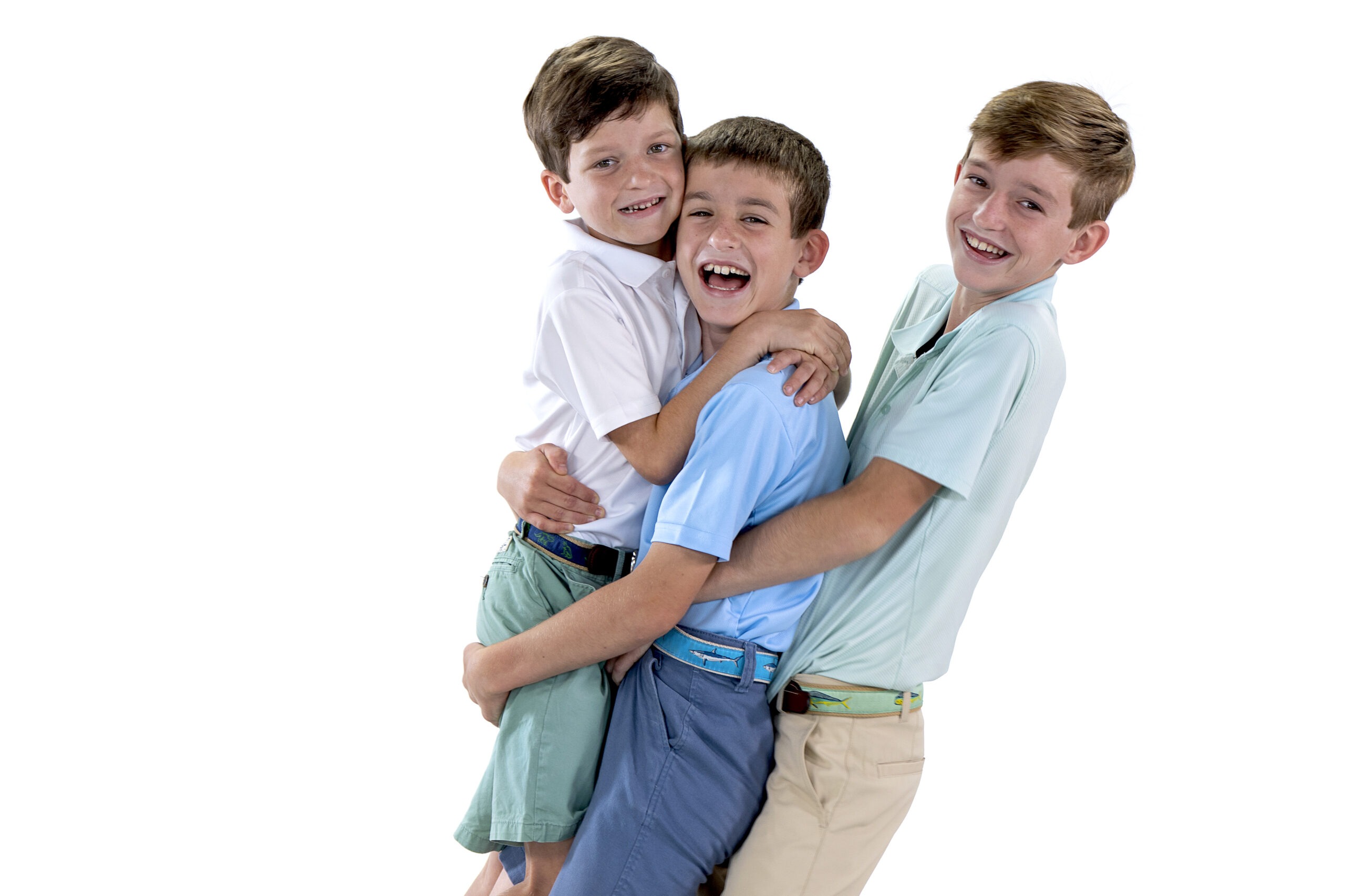 Studio family portrait of three brothers from the Irish family, captured in joyful embrace and laughter by professional photographer David Scarola in Jupiter, Florida. Bright, modern white-background studio photography showcasing connection, personality, and fine-art family portraiture.studio family photography Jupiter FL, Palm Beach family photographer, professional portraits Palm Beach County, fine art family portraits, studio photo session South Florida, children and family photographer, Scarola Style portraits, best photographer Jupiter Island, sibling portraits, modern family photography Florida.