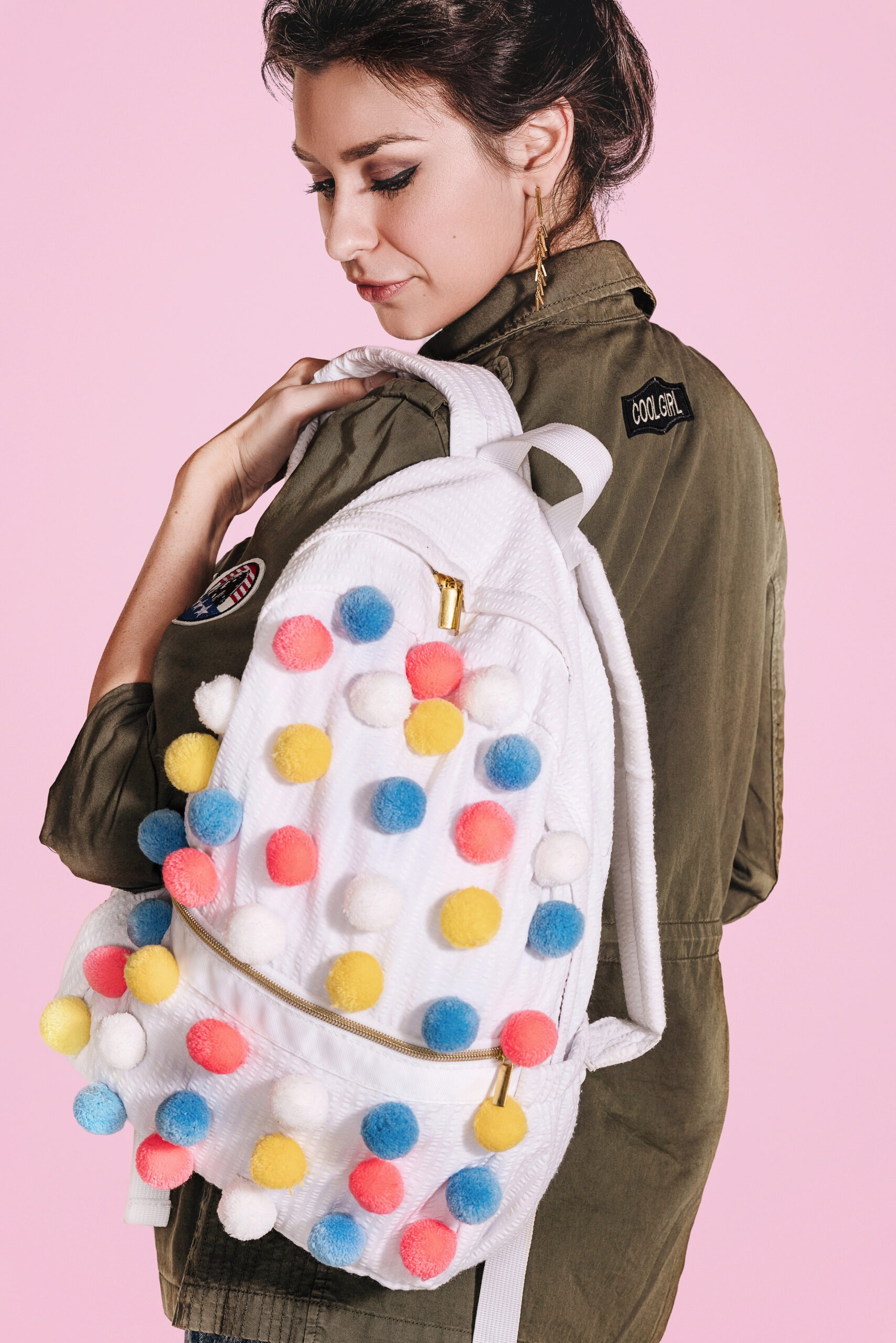 Studio fashion photography of a woman wearing a playful Palm Beach Crew backpack designed by Nikiani Inc, captured by master portrait artist David Scarola in Palm Beach County, Florida.