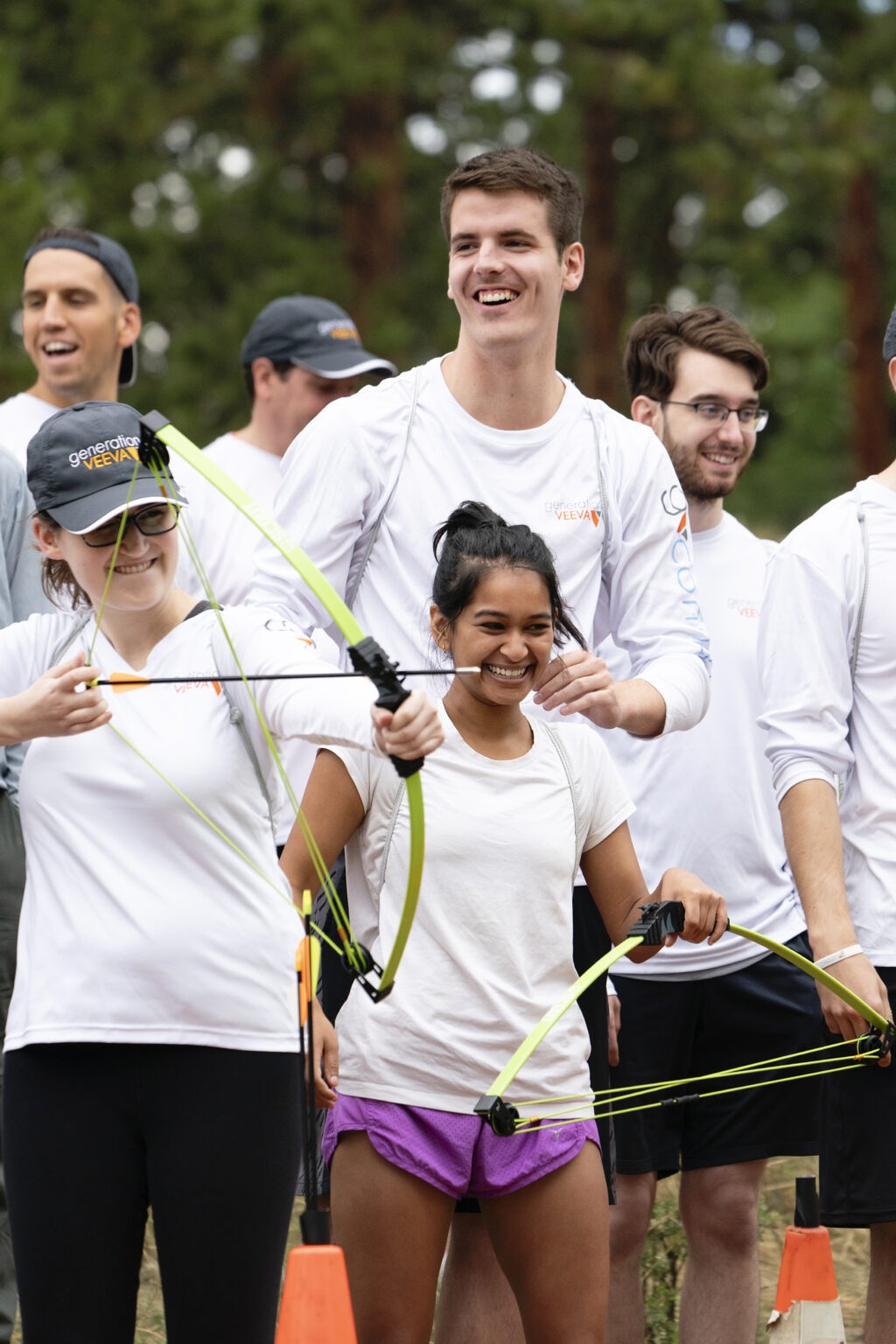 Corporate team-building archery activity in Denver with Veeva Systems employees smiling and collaborating outdoors — captured by David Scarola Photography, showcasing authentic corporate adventure and leadership culture.Veeva Systems Denver, corporate adventure photography, global corporate retreat, team building photography, corporate event photographer Colorado, Denver event photography, outdoor leadership event, company retreat photographer, global business event photographer, innovation culture photography, executive offsite coverage, David Scarola Photography, corporate lifestyle photography, brand storytelling photography, professional event coverage, worldwide corporate retreats, Generation Veeva, high-end corporate photography.