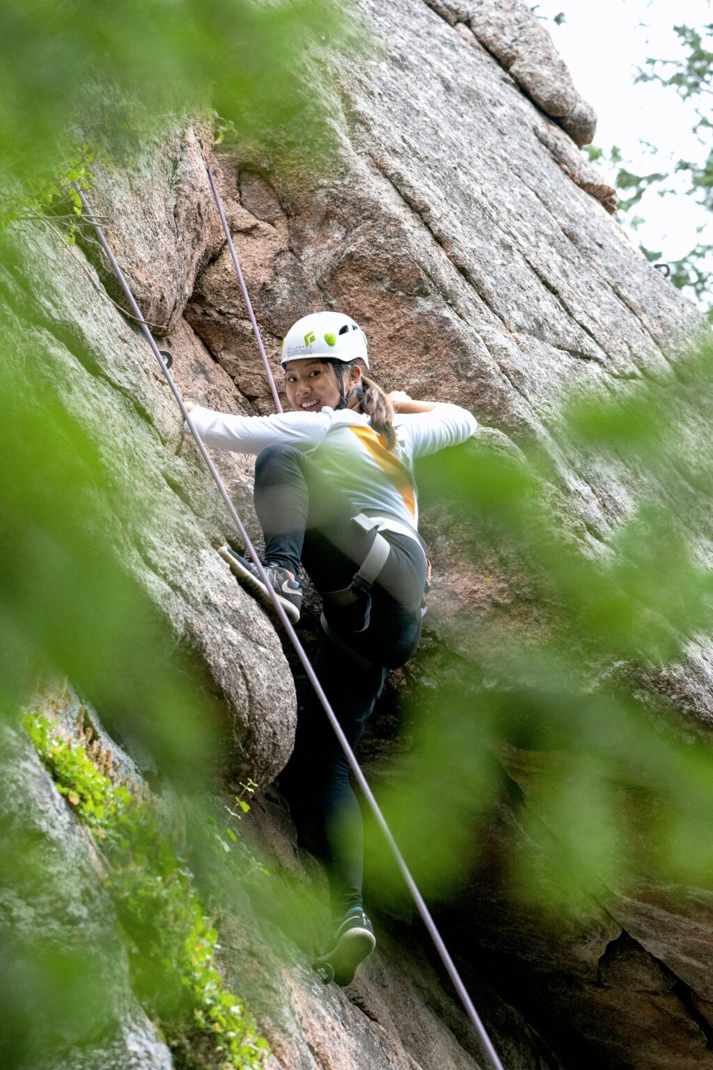Corporate adventure photography — Veeva Systems team member rock climbing in Denver, Colorado during a global leadership and team-building retreat. Captured by David Scarola Photography, showcasing courage, focus, and connection through outdoor corporate adventure.