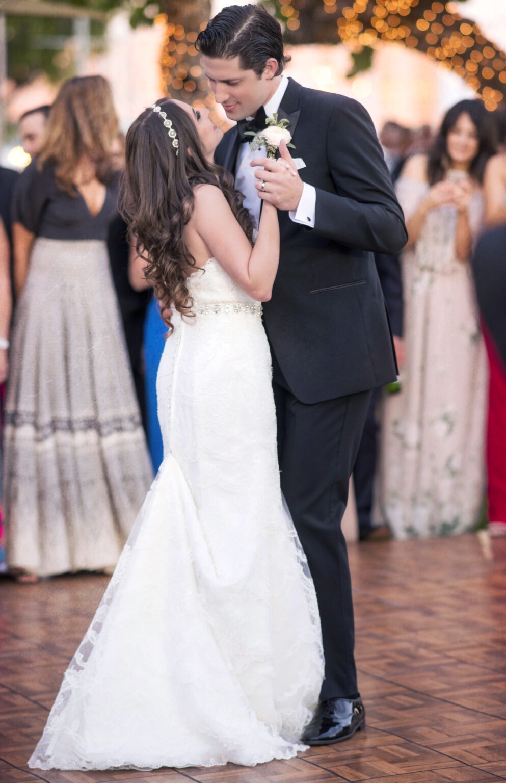 Bride and groom share their romantic first dance under twinkling lights at the Miami Yacht Club, surrounded by loved ones. Captured with cinematic warmth and emotional precision by David Scarola — an award-winning South Florida wedding photographer celebrated for his painterly lighting, intuitive timing, and storytelling mastery that transforms fleeting moments into enduring works of art.