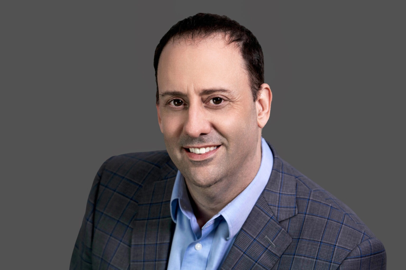 Professional studio headshot of a business executive photographed by David Scarola Photography. Clean gray backdrop, confident expression, and natural lighting — ideal for business professionals, executives, and corporate leaders in Palm Beach, Jupiter Island, and Miami.executive headshots Palm Beach, professional portrait photography South Florida, Miami corporate headshots, Jupiter Island business photographer, best headshot photographer Palm Beach, studio portraits Miami, corporate photography Florida, business headshots Jupiter Island, professional branding portraits Palm Beach, corporate photographer David Scarola, leadership portraits South Florida, Miami executive photography, professional headshot sessions Palm Beach, corporate image branding