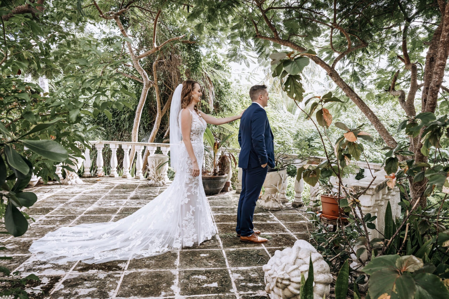 Bride and groom’s emotional first look at their destination wedding in Eleuthera, The Bahamas. Captured by world-class photographer David Scarola, this fine-art wedding portrait showcases the couple surrounded by lush tropical foliage and romantic natural light, blending cinematic composition with authentic storytelling.