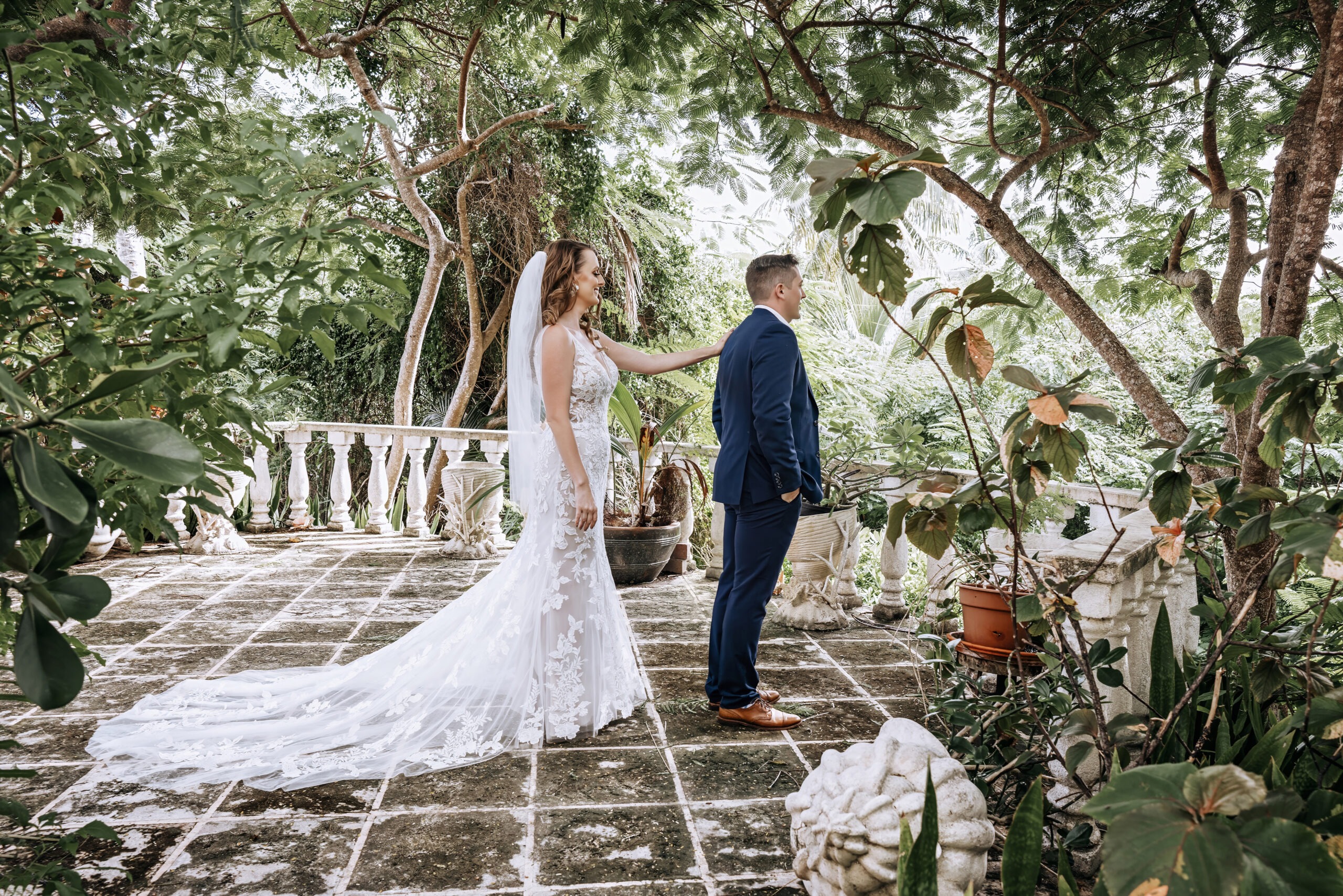 Bride and groom’s emotional first look at their destination wedding in Eleuthera, The Bahamas. Captured by world-class photographer David Scarola, this fine-art wedding portrait showcases the couple surrounded by lush tropical foliage and romantic natural light, blending cinematic composition with authentic storytelling.
