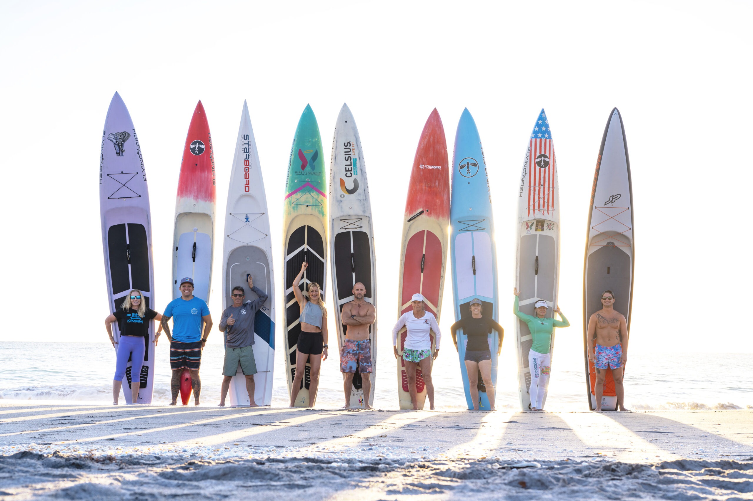 Group of elite paddleboarders from Team Elemental Performance standing proudly with their boards on the beach at sunrise during the International Paddle Boarding Summit in Palm Beach, Florida. Captured by David Scarola Photography, showcasing the spirit of adventure, athleticism, and unity in the stand-up paddle world.International Paddle Boarding Summit, Palm Beach paddleboarding, Team Elemental Performance, stand up paddle photography, SUP world championships, adventure sports photographer Florida, global adventure photography, athletic lifestyle photography, water sports photography, sunrise beach photography, paddleboard team portraits, professional event photographer, David Scarola Photography, Palm Beach adventure photography, international paddleboard event.