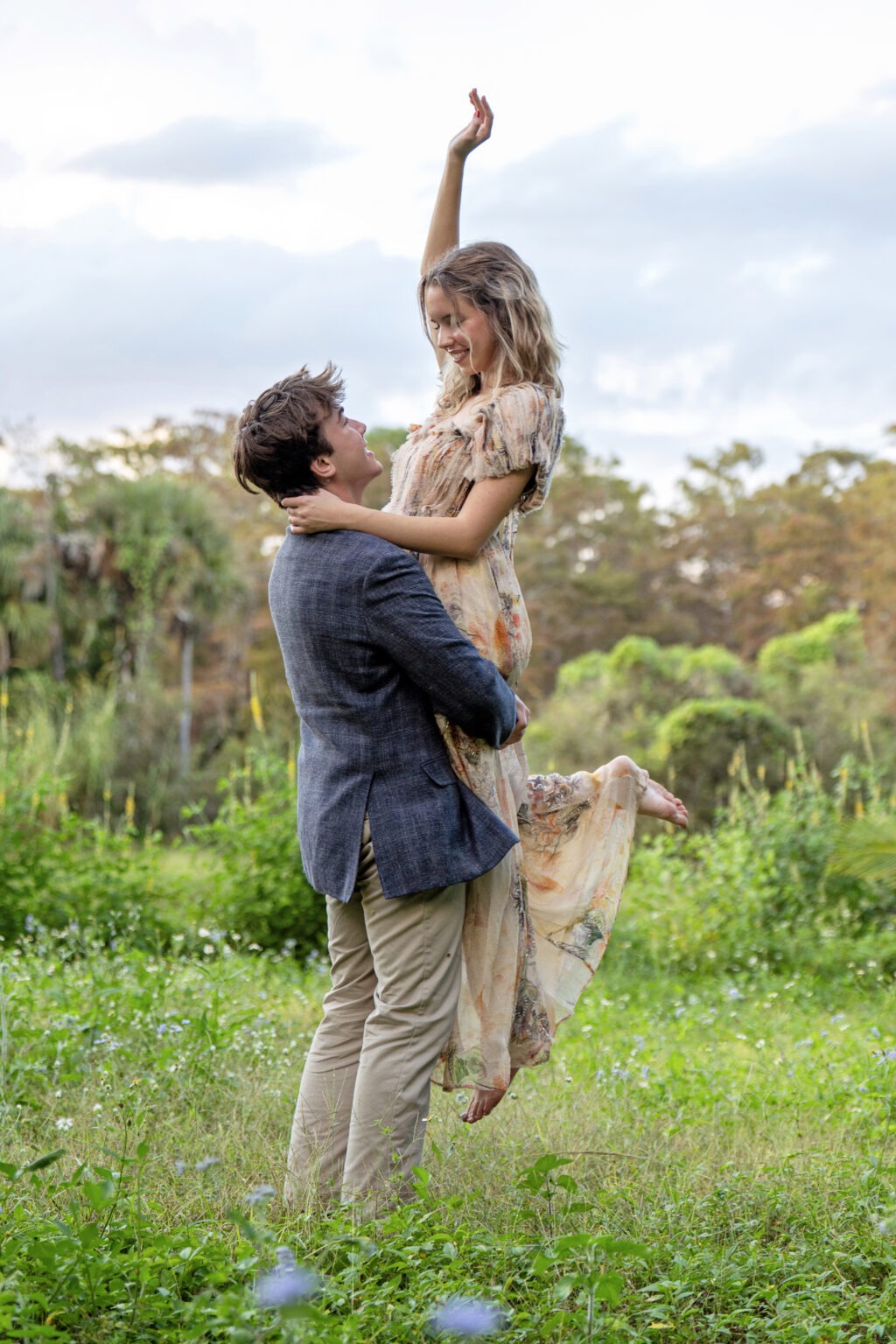 Lucy and her boyfriend Brody during a golden-hour photo session in Jupiter Island, Florida — a joyful embrace captured in nature, blending the warmth of senior photography with the romance of an engagement-style portrait. Captured by David Scarola Photography, Palm Beach’s top-rated family and portrait photographer.senior portraits Jupiter Island, engagement photographer Palm Beach, Jupiter Florida portrait photographer, lifestyle couples photography, senior photo ideas South Florida, family photographer Palm Beach County, David Scarola Photography, natural light portrait photographer, romantic outdoor photography, Florida engagement photo shoot.