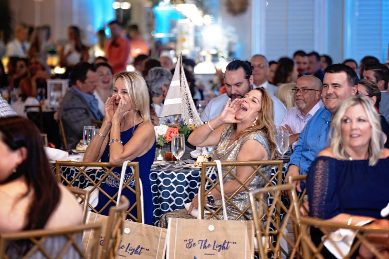 Guests cheer and celebrate during the Be The Light Gala for the Live Like Jake Foundation at the Pelican Club, Jupiter Island. Captured by David Scarola Photography, this candid event image highlights joy, connection, and the heartfelt spirit of philanthropy in action.Be The Light Gala, Live Like Jake Foundation, Pelican Club Jupiter Island, Palm Beach charity gala photography, luxury event photographer Florida, nonprofit gala photographer, philanthropic event photography, Jupiter Island gala, emotional event moments, David Scarola Photography, storytelling event photography, Palm Beach event coverage, fine art event photography, professional gala photographer Florida.
