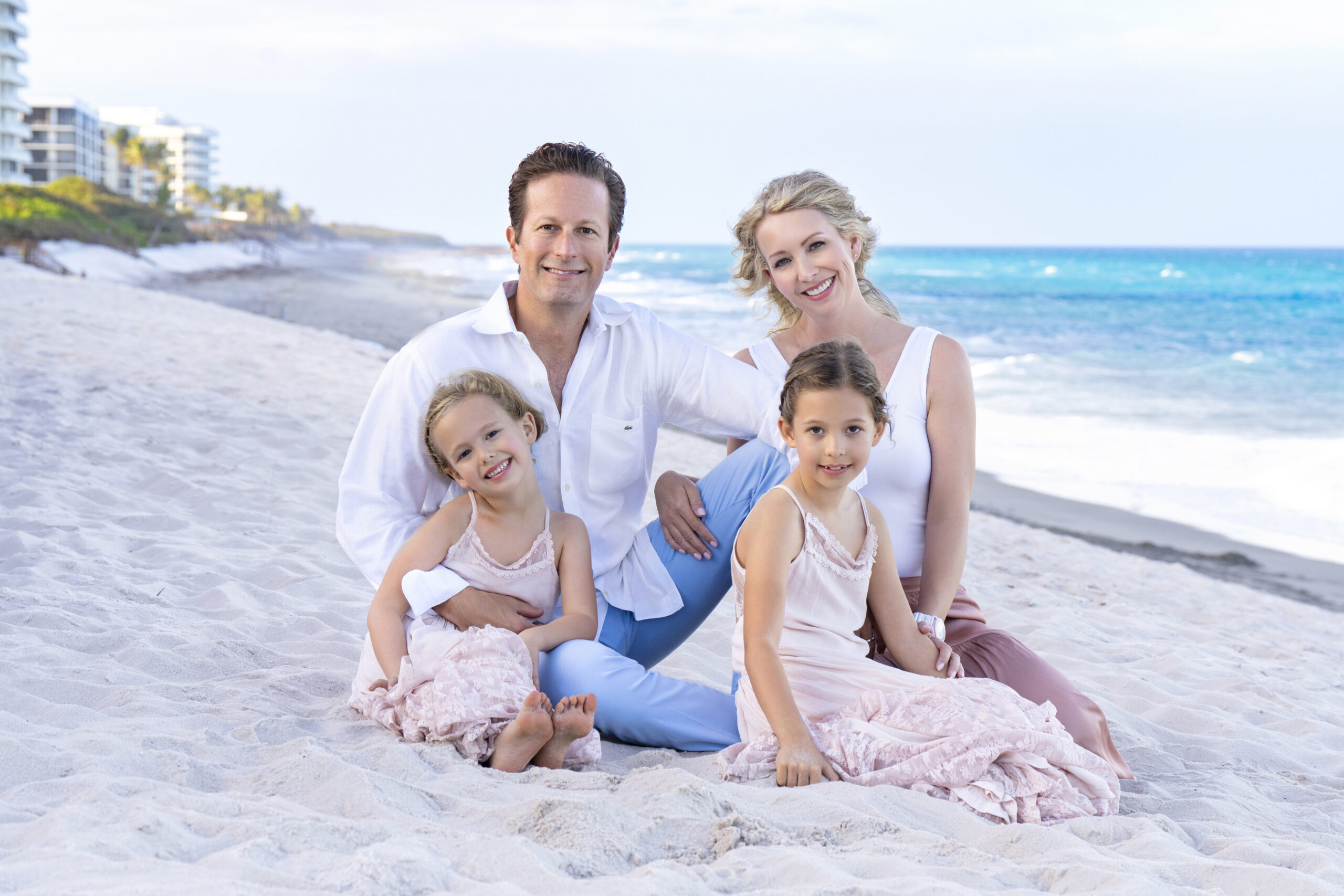 Family portrait session on Jupiter Island Beach at sunset — parents Chris and Amy Baj with their two daughters, captured by master photographer David Scarola.Jupiter Island family photography, Palm Beach County photographer, sunset family portraits, family beach photo shoot Florida, fine art family portraits, master portrait artist, David Scarola Photography, top-rated family photographer USA, luxury family photo sessions Jupiter Island