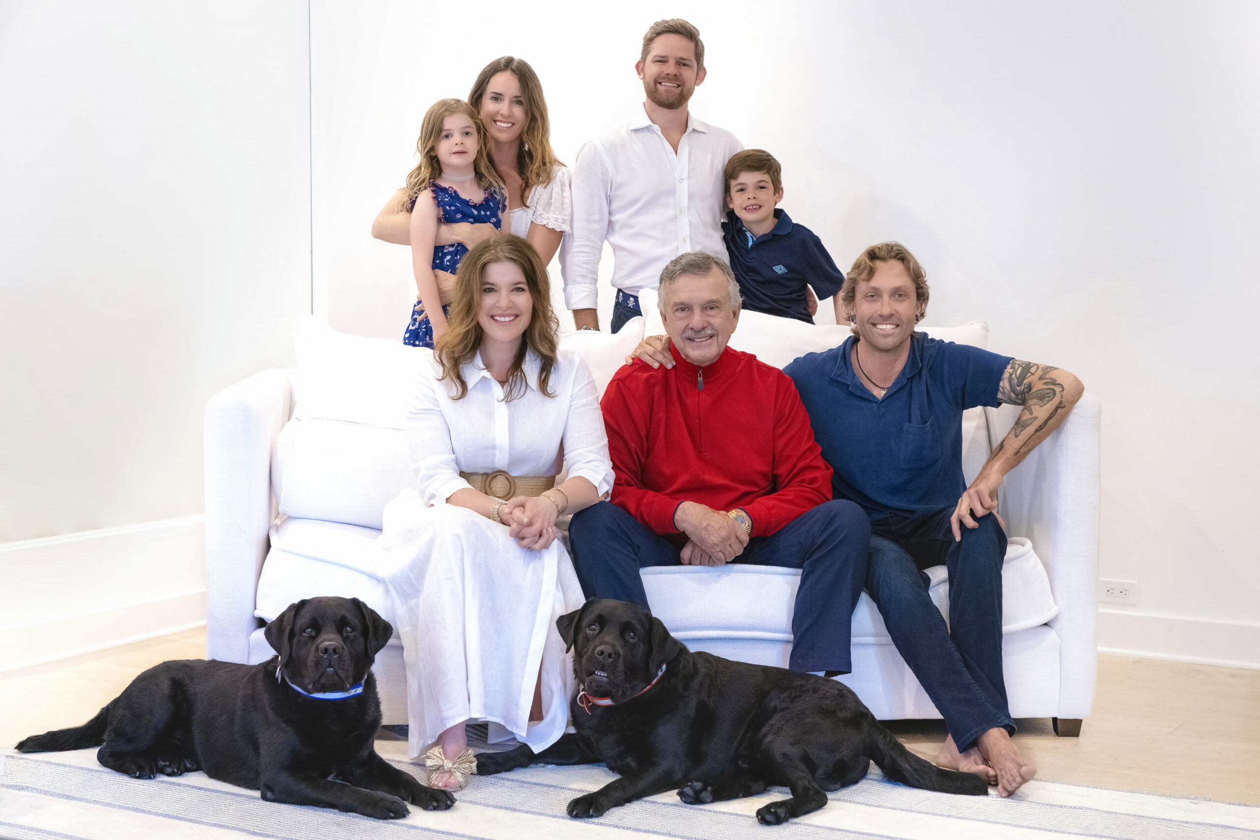 This gorgeous family and their beautiful black labs were masterfully guided into position for this family portrait taken during their Palm Beach Island Beachfront Condo photo shoot with the best family photographer in Florida, David Scarola.