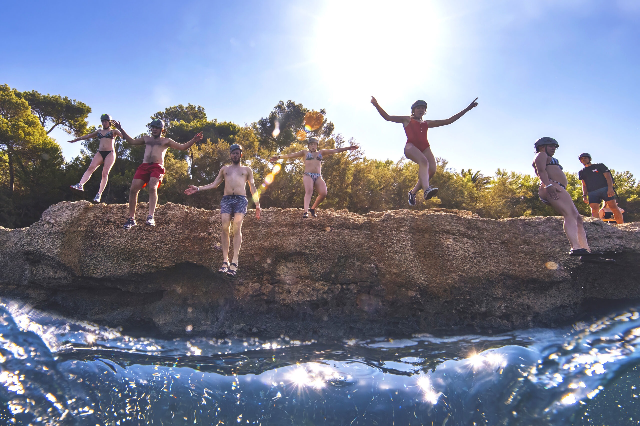 Veeva Systems global team cliff jumping into the Mediterranean during a corporate adventure retreat in Mallorca, Spain — captured by David Scarola Photography, world-class event and adventure photographer.Veeva Systems Mallorca photography, global corporate retreat Spain, team building adventure photography, worldwide corporate event photographer, David Scarola Photography, international company retreat, adventure event photographer Mallorca, global summit photographer, luxury event photographer Europe, Mediterranean corporate photography, worldwide brand storytelling photographer.