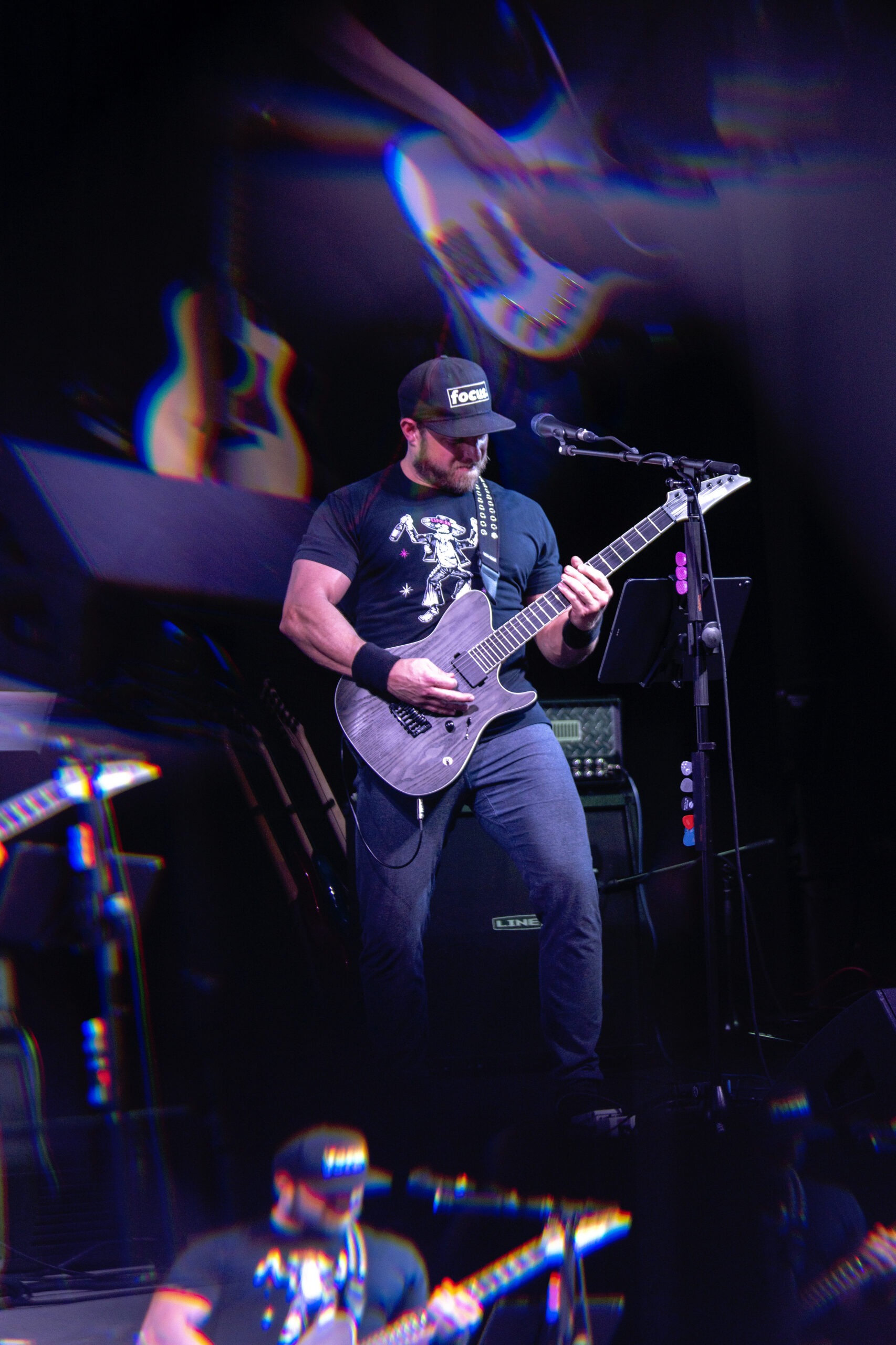 Disbarred band live at iTHINK Amphitheatre — lead guitarist performing under neon lights. The focus is intense, energy electric, and atmosphere cinematic with multicolor lighting effects. Captured by David Scarola Photography, a master of concert and live event photography in Florida.Disbarred band photography, iTHINK Amphitheatre concert, live music photographer Florida, concert event photography Palm Beach, David Scarola Photography, Florida concert photographer, Jupiter event photographer, live event coverage, music photography USA, performance photographer South Florida