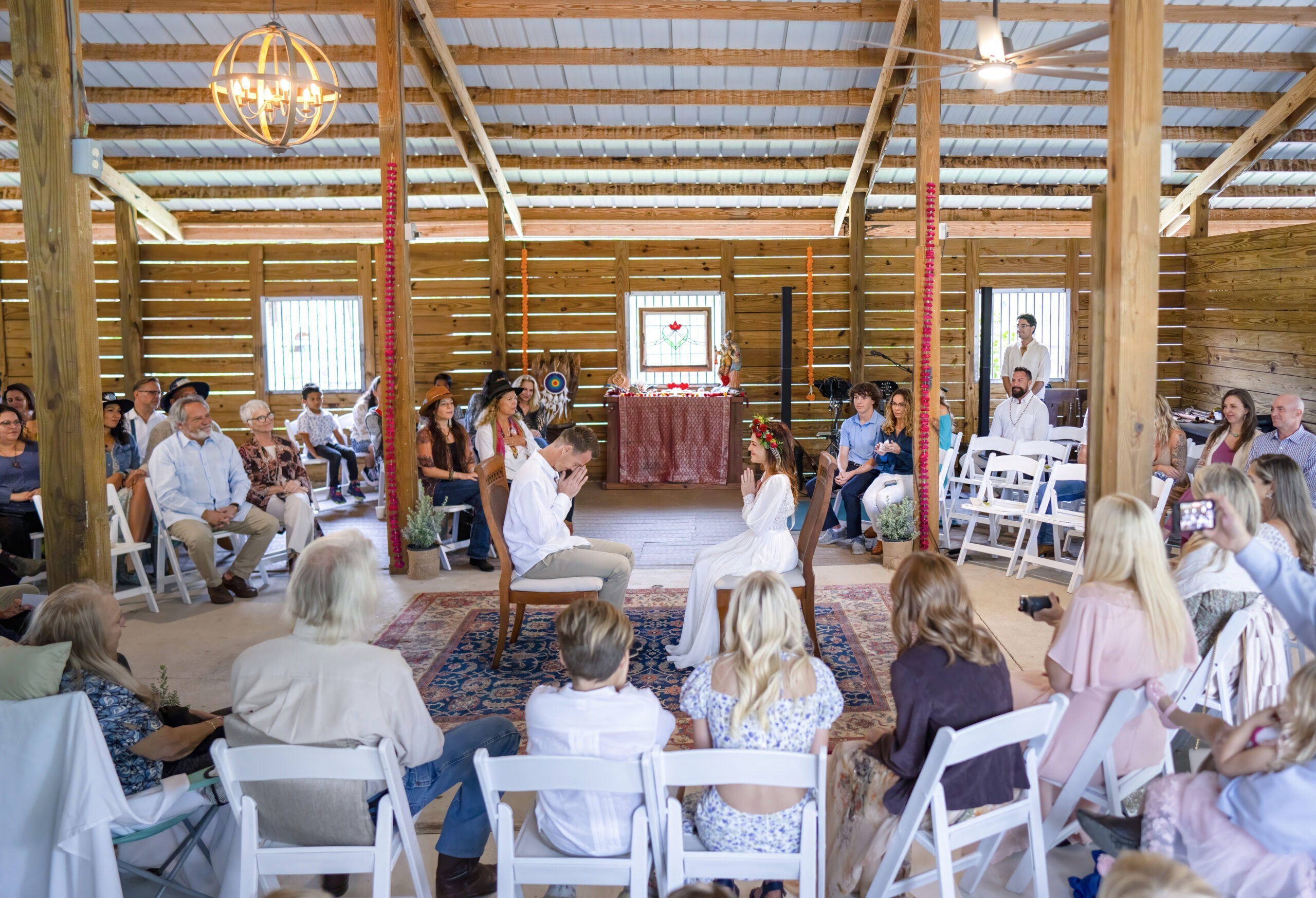 Bride and groom exchange heartfelt vows during their wedding ceremony at Hawks Landing in Jupiter, Florida. Captured by award-winning fine art wedding photographer David Scarola, this image beautifully frames the intimacy and emotion of the day — blending candid storytelling with masterful light and composition for a natural, documentary-style moment filled with authenticity and soul.