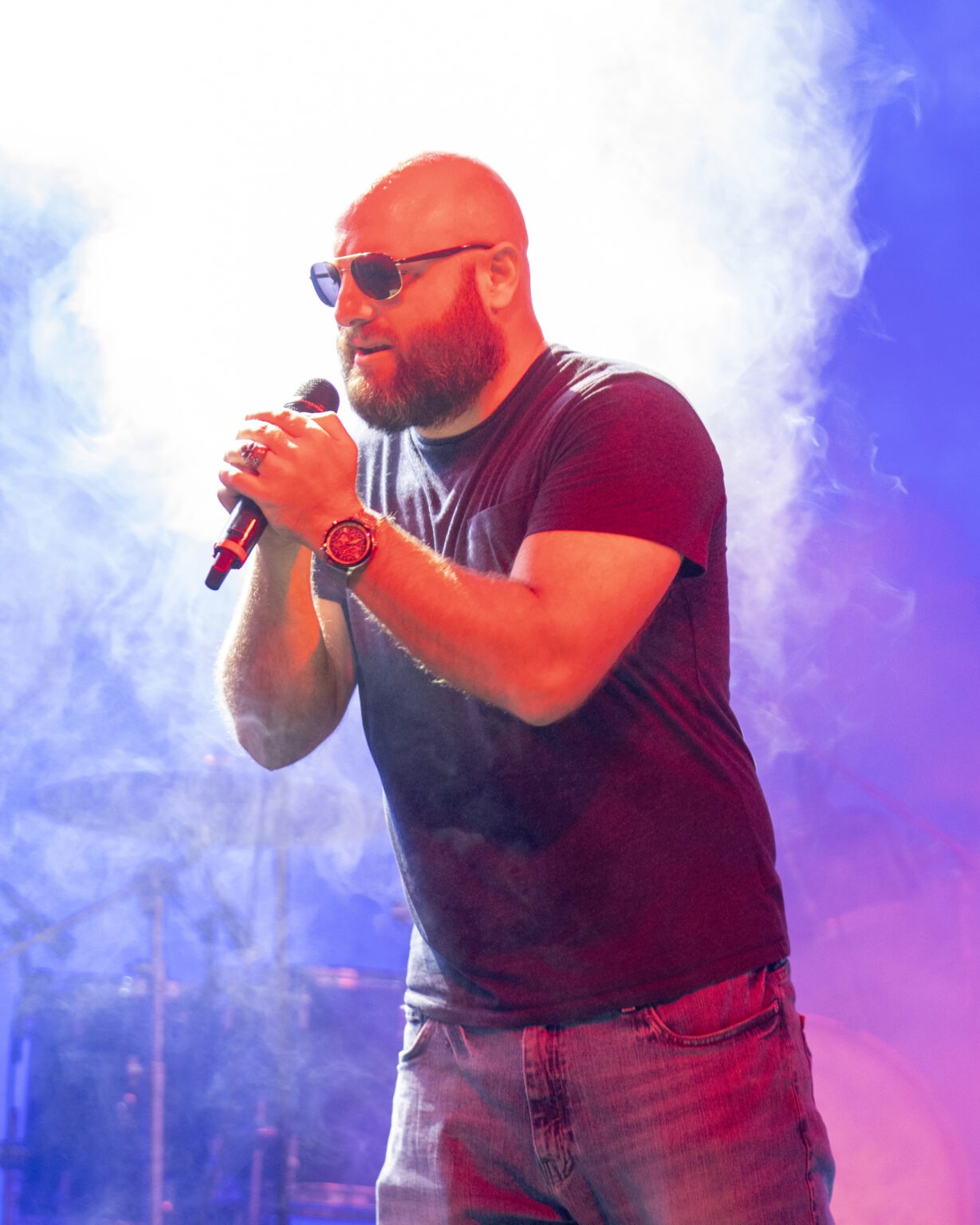 Lead singer performing live with Disbarred at iTHINK Amphitheatre, captured mid-song in a haze of stage light and smoke. A powerful rock performance moment by Florida’s high-energy band, photographed by David Scarola Photography.