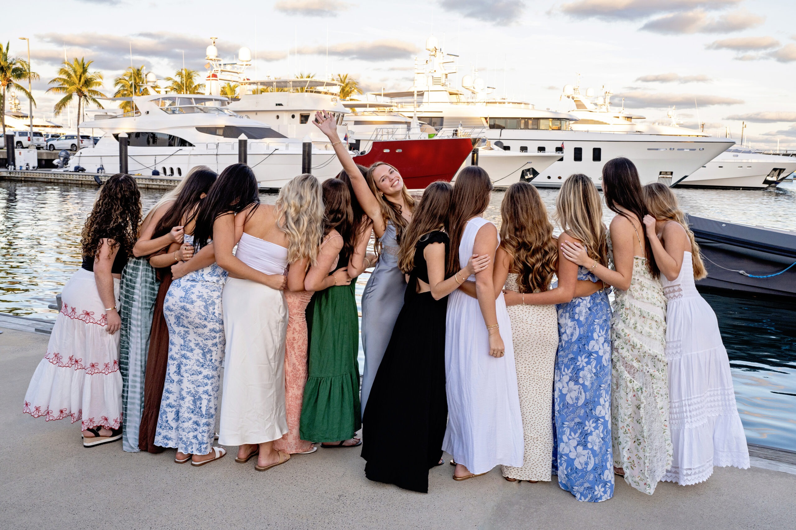 A joyful group of best friends embracing at LaMarina, Rybovich Marina in West Palm Beach, celebrating Addison’s 18th birthday private function. Captured in radiant golden light by master photographer David Scarola, showcasing expert direction, posing, and connection in lifestyle portraiture.David Scarola Photography, Addison’s 18th birthday, LaMarina Rybovich Marina, West Palm Beach photographer, luxury event photography, lifestyle portraiture, fashion photographer Florida, master of posing and people, fine art celebration, Scarola Style, Palm Beach photography, best portrait photographer Florida.