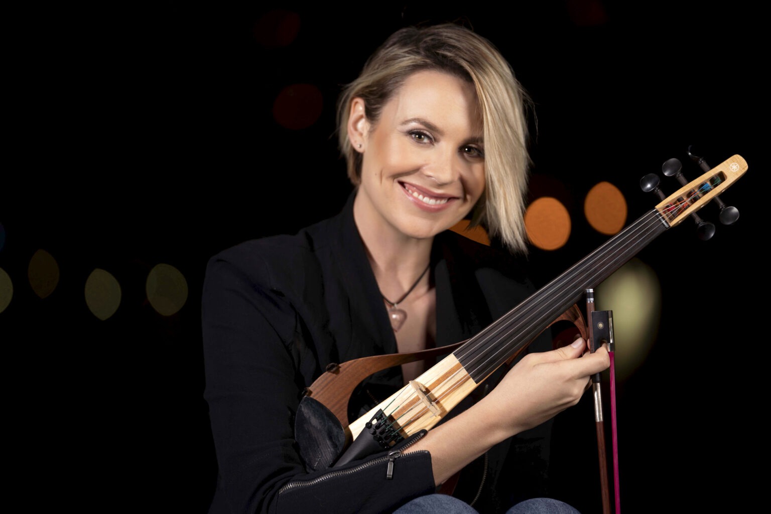 Professional portrait of Bonnie, a violinist, photographed by David Scarola Photography. Smiling headshot with violin under night lights, blending fine art, lifestyle, and editorial photography. Shot in West Palm Beach, Florida — musician branding and professional headshot photography for artists in Miami, Jupiter Island, and Key Biscayne.