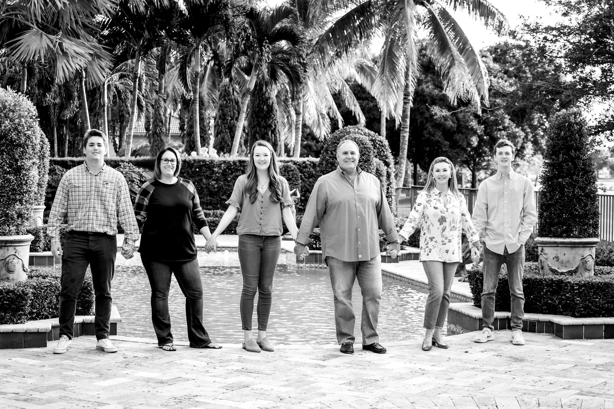 A wonderful black and white family portrait of a lovely family living on Palm Beach Island, who decided their backyard would be the ideal setting for their family photo shoot with the highly regarded professional portrait artist, David Scarola Photography.