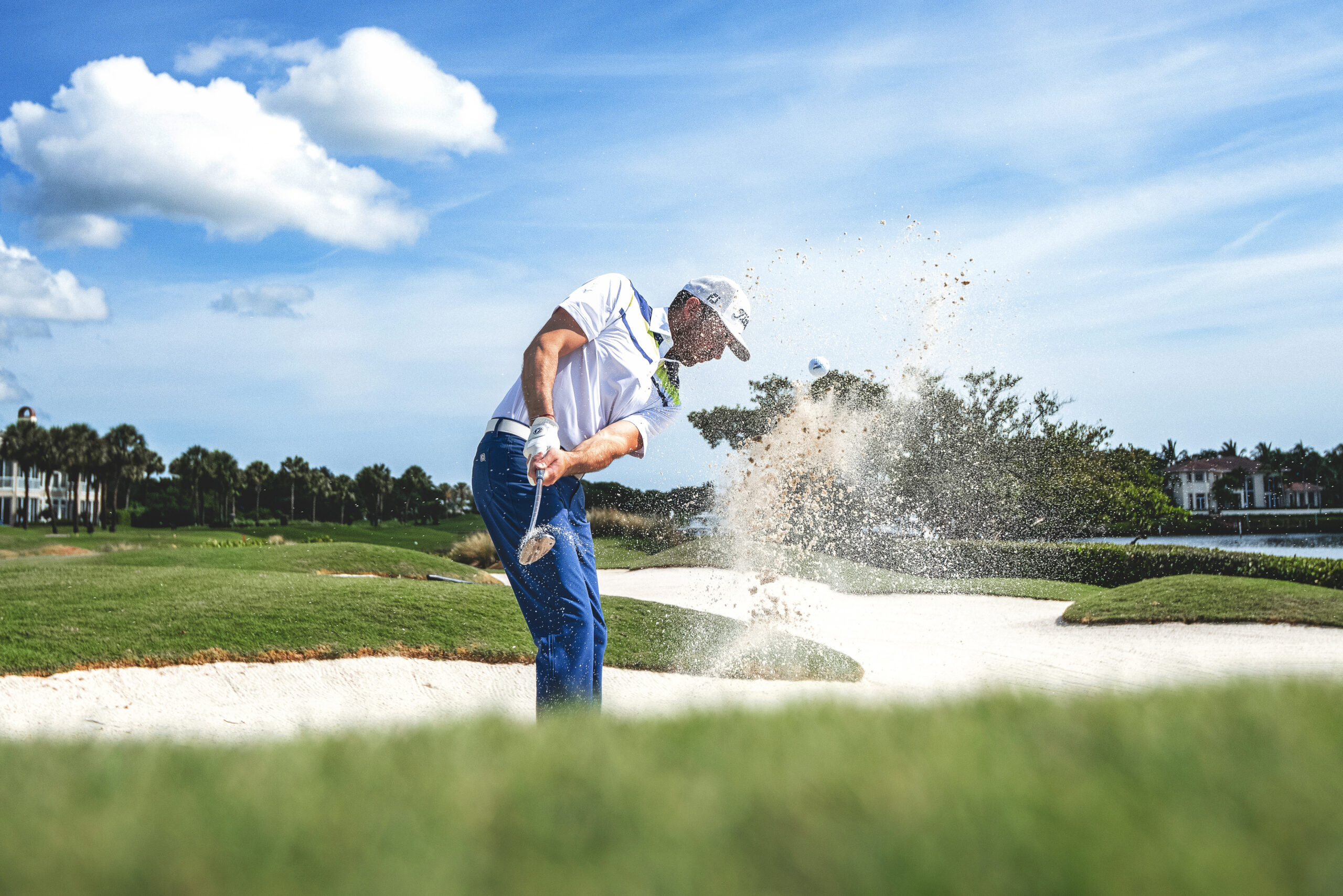Professional golf lifestyle photograph captured at Admirals Cove, the premier private country club in Jupiter, Florida, featuring Titleist athlete and influencer Arnaud Serie in mid-swing from a bunker. Photographed by David Scarola, one of the top commercial and lifestyle photographers in Palm Beach and the United States. The shot captures precision, motion, and energy — showcasing Titleist’s commitment to performance and luxury within one of Florida’s most prestigious golf communities.David Scarola Photography, Titleist golf photoshoot, Admirals Cove Jupiter Florida, Jupiter Island golf photography, Palm Beach commercial photographer, golf lifestyle branding, professional golfer photoshoot, Titleist campaign, Arnaud Serie golf influencer, luxury golf club photography, fine art sports photography, Palm Beach lifestyle photographer, Jupiter Florida golf course, Titleist brand imagery, high-end commercial photographer Florida, Scarola style photography, professional golf branding, Admirals Cove country club, golf influencer content creator, luxury sports marketing photography.