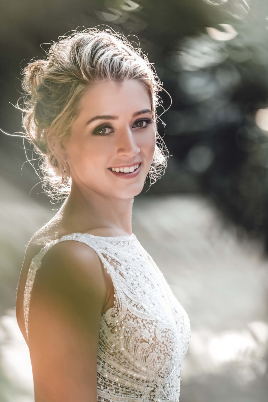 Radiant bride captured in soft natural light, her elegant beaded gown shimmering as she smiles gracefully toward the camera — photographed with depth, warmth, and artistry by David Scarola, Florida’s best wedding photographer and fine-art portrait master known for timeless, luminous bridal imagery across Palm Beach and Jupiter Island.
