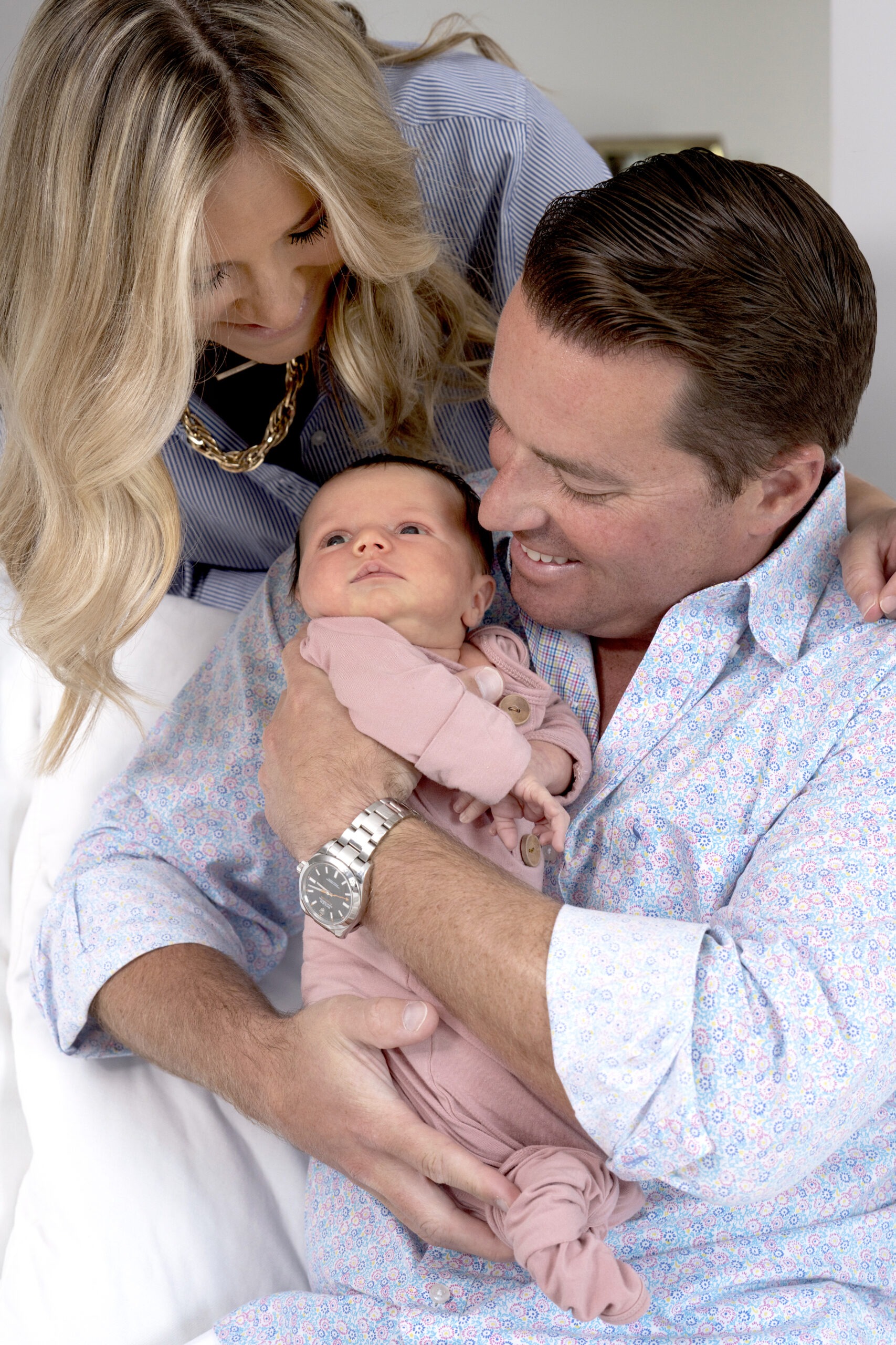 Newborn family portrait of proud parents with their baby girl during an in-home photo session in Palm Beach Island, captured by David Scarola Photography. A tender, lifestyle moment that celebrates love, connection, and new beginnings.Palm Beach Island newborn photography, family photographer Palm Beach, professional newborn portraits, in-home family photography Florida, lifestyle baby photography Palm Beach, top portrait photographer Jupiter Island, David Scarola Photography, family photo shoot Palm Beach, elegant newborn portraits Florida, South Florida family photographer.