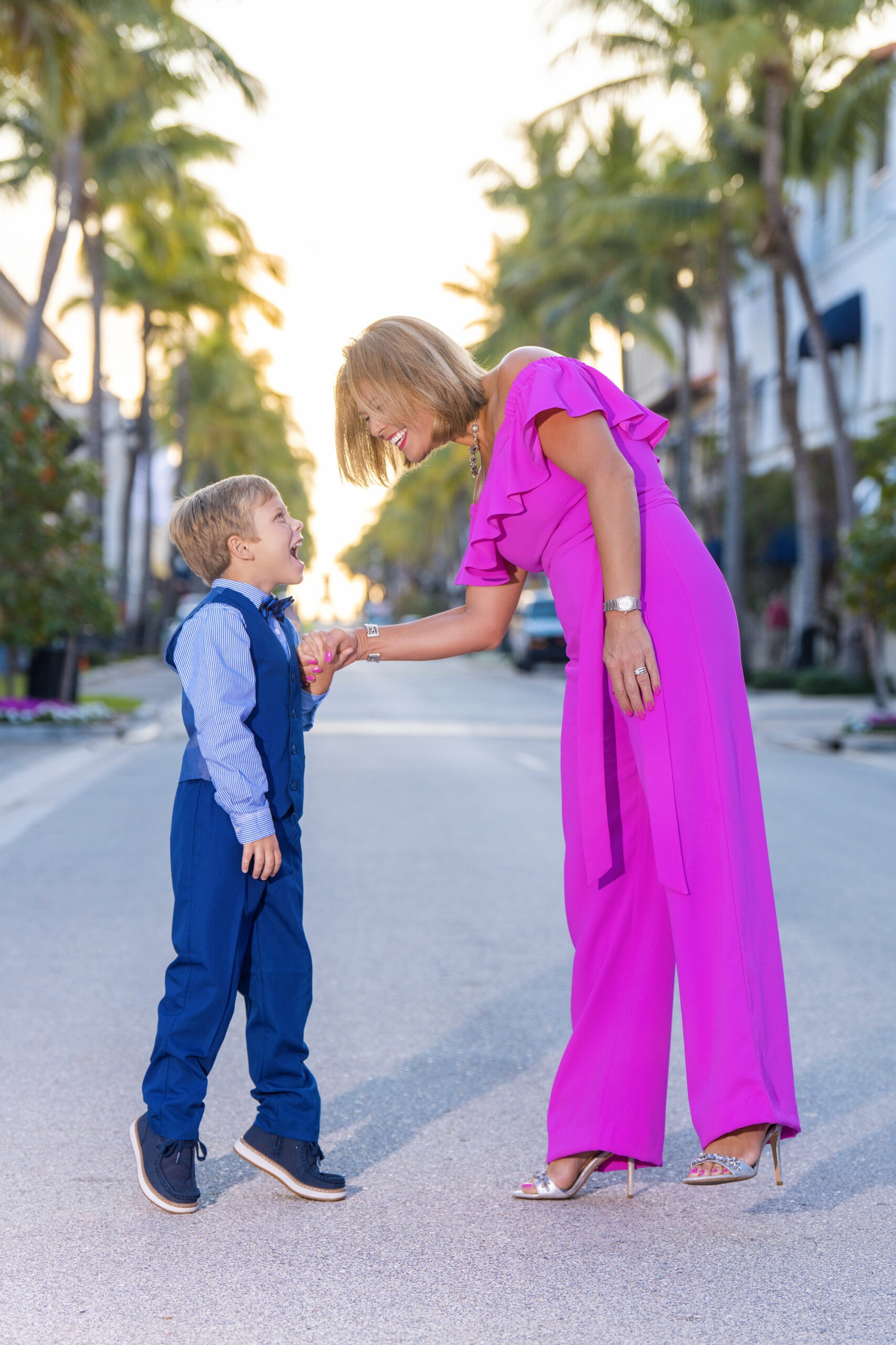 Mommy and darling son having a playful and happy moment together prompted by the talented family photographer, David Scarola, who brought his clients to Worth Avenue on Palm Beach Island early on a Sunday morning, before the rush of the day made everything busy and congested.