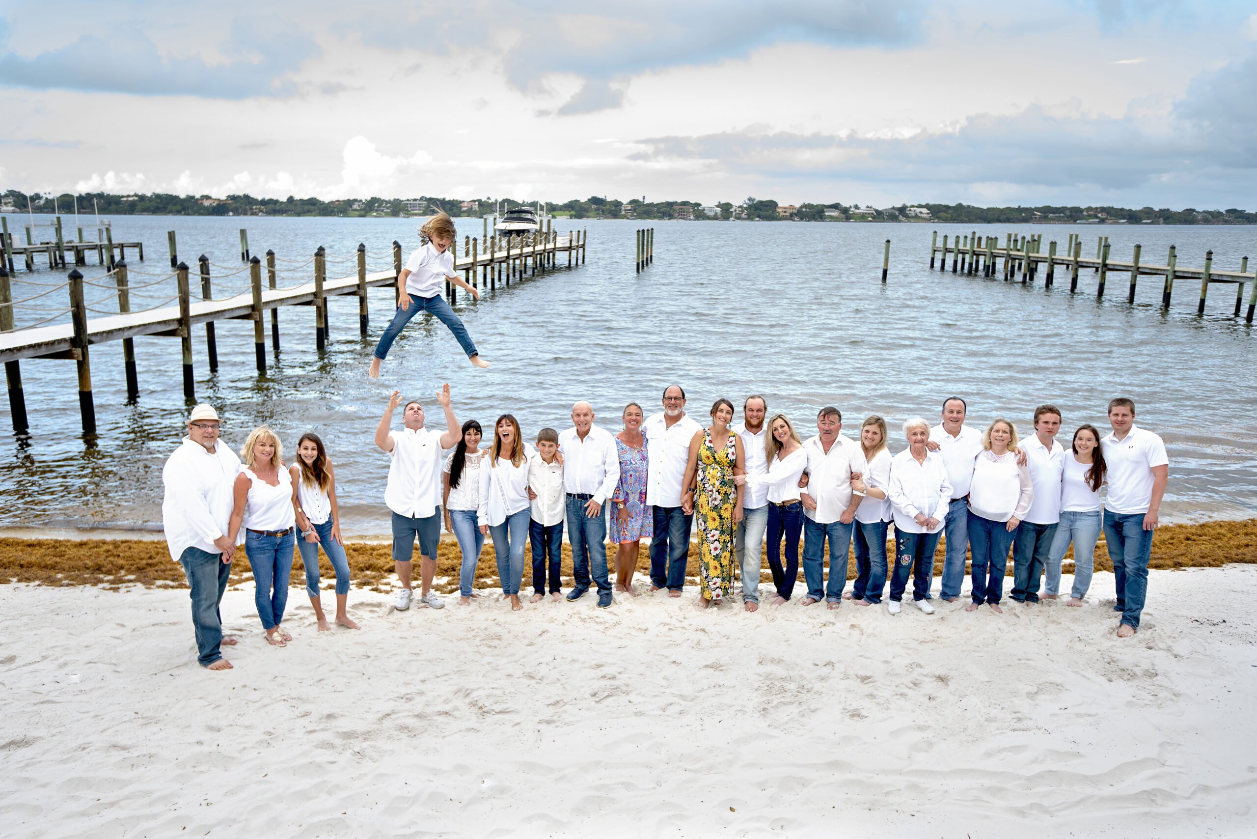 When a large family wants to make a gorgeous, fun, and perfectly fitting family portrait, someone ought to throw the youngest and bravest little boy in the family high into the air and for sure that will make the Jupiter Island family photo session the best it could possibly be. Ready, go, call David Scarola for your amazing large family photo shoots.